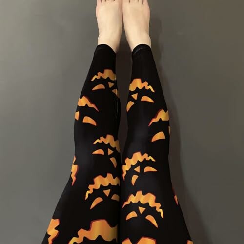 Legs wearing Halloween pumpkin patterned leggings.