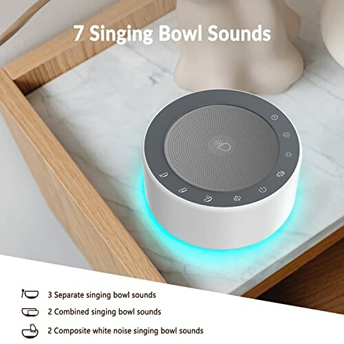 Singing bowl sound machine with multiple sound options on a table.