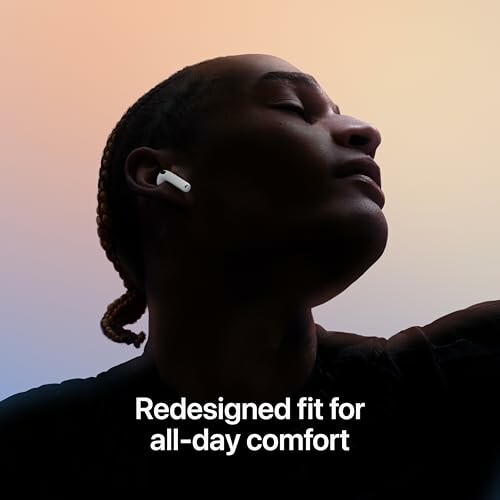 Person wearing wireless earbuds with text 'Redesigned fit for all-day comfort'