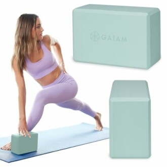 Woman using a yoga block in a stretching pose on a mat